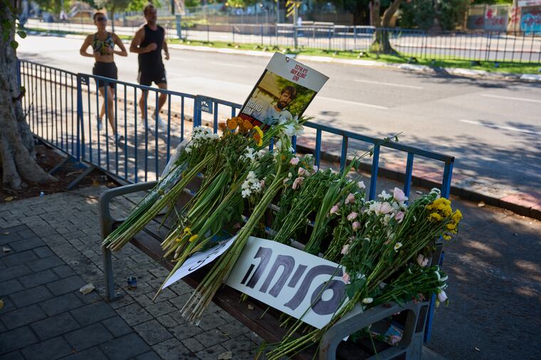 Flowers and a sign written in Hebrew that reads "Sorry" were placed on a bench outside Abu Kabir, the forensic institute in Israel where the identification process is being carried out on the four bodies that were held by Hamas in the Gaza Strip.