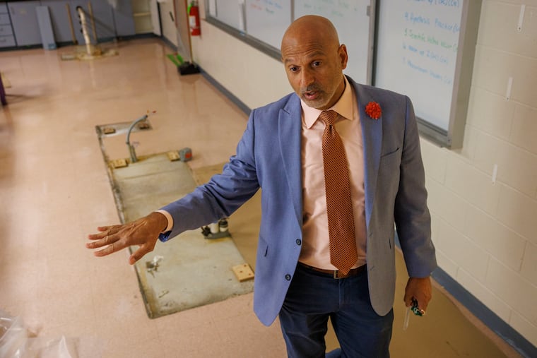 Interim Superintendent Mark Pease explains water damage in a science classroom during a tour of Winslow Township Middle School this month. Repairs are needed in about 28 classrooms, two gyms, the library, main office, and entrance to the school.