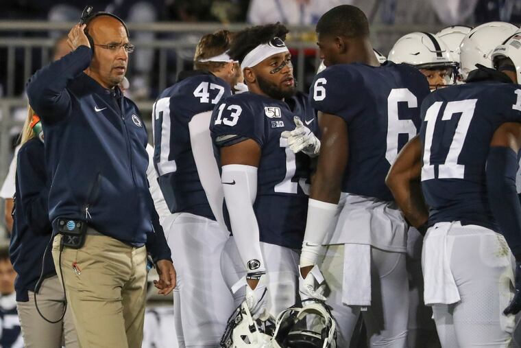 Penn State head coach James Franklin (left) with his team in 2019. The coach has lots of extra challenges this season.