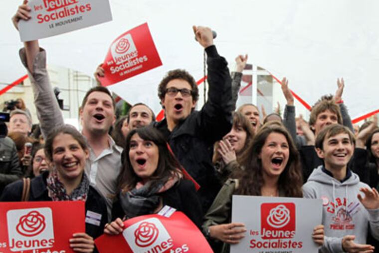 French Socialist Party supporters react at the results of the first round of the legislative elections in Paris, France, Sunday, June 10, 2012. French voters are going to the polls in legislative elections for the lower house of parliament, which will determine whether new President Francois Hollande's Socialists or rival conservatives control the government. (AP Photo/Francois Mori)