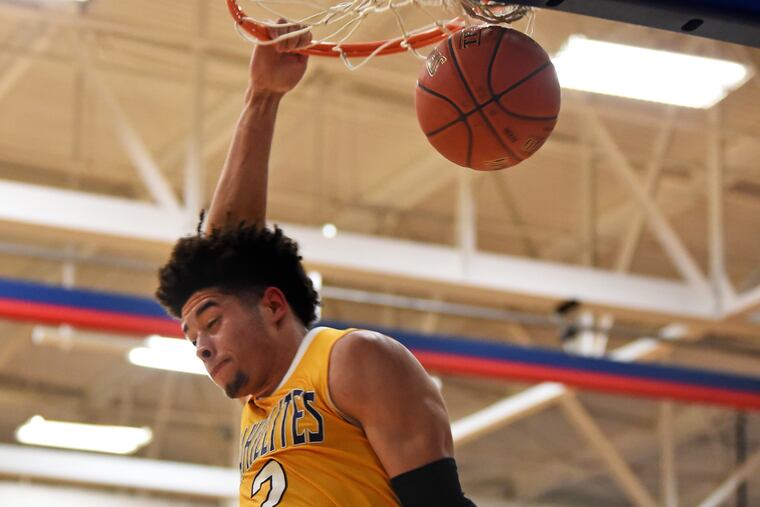 Roman Catholic's Seth Lundy slam dunks against Lower Merion on the way to winning their PIAA Class 6A second-round game.