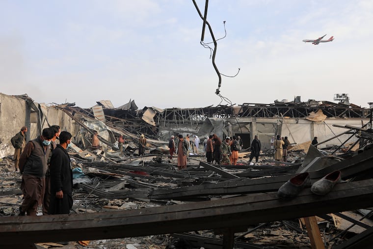 Residents and volunteers inspect the site of a late-Monday airstrike at a drug rehabilitation hospital in Kabul, Afghanistan, Tuesday, March 17, 2026.