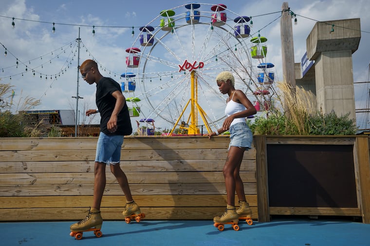 Aquila Rogers, left, from West Philadelphia, and Nakia Moore, right, from Brooklyn, roller-skate at the Blue Cross RiverRink Summerfest at Penn's Landing on a summer day, in Philadelphia, Friday, August 17, 2018.