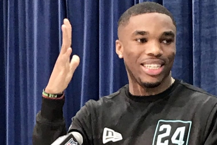 Ohio State cornerback Jeffrey Okudah holds up his damaged pinky for inspection by reporters Friday at the NFL scouting combine in Indianapolis.