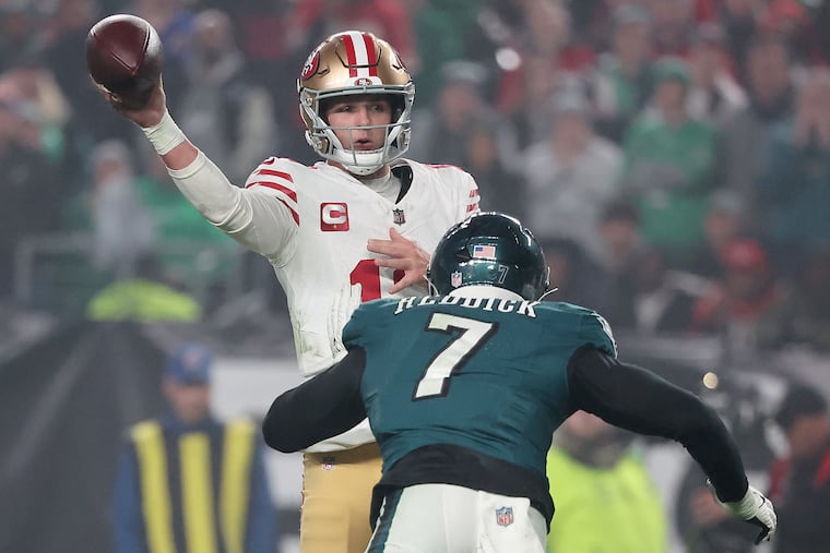 San Francisco quarterback Brock Purdy passes against the Eagles on Dec. 3 as Haason Reddick closes in.
