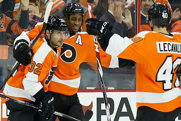 Mark Streit celebrates a goal with teammates Wayne Simmonds and Vincent Lecavalier. (Yong Kim/Staff Photographer)