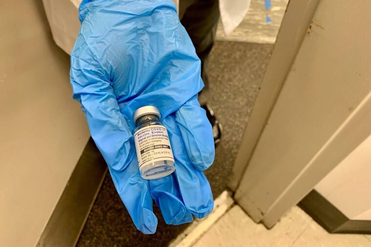 A nurse at a Walgreens pharmacy near Florida International University's Tamiami campus on 107th Avenue in Miami-Dade shows a patient the newly formulated Moderna bivalent vaccine on Sept. 7, 2022. The vaccine is an "updated booster" designed to target not only the original COVID-19 strain, but also omicron BA.4 and BA.5, which had surged in the U.S. in 2022. (Howard Cohen/Miami Herald/TNS)