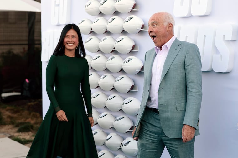 Eagles owner Jeffrey Lurie (right) with partner Tina Lai, moved up 56 spots to No. 191 on the latest Forbes list of the 400 wealthiest Americans.