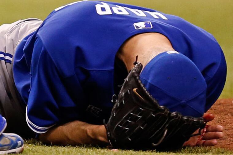 Former Phillie J.A. Happ reacts after being hit in the head by a line drive from Tampa Bay Rays' Desmond Jennings during the second inning of a baseball game Tuesday, May 7, 2013, in St. Petersburg, Fla. (Mike Carlson/AP)