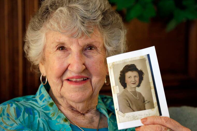 Laura Mae Davis Burlingame, 90, holds a high school photo of herself. The picture filled the back cover of a diary she had given to a Marine who died on Peleliu.