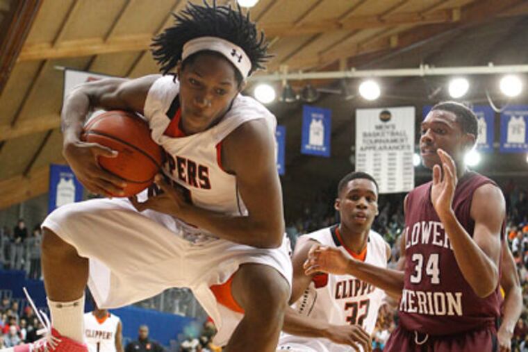 Chester's Shanier Cottman grabs a rebound next to Lower Merions' Raheem Hall. (Ron Cortes/Staff Photographer)