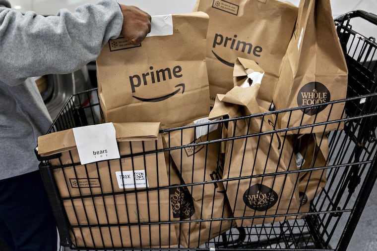 Amazon Prime grocery bags ready for delivery outside a Whole Foods in Washington, D.C., in March 2020.