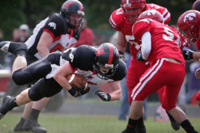 Haddonfield's Chris Davis dives for extra yardage but comes up just short of a first down against Haddon Township.