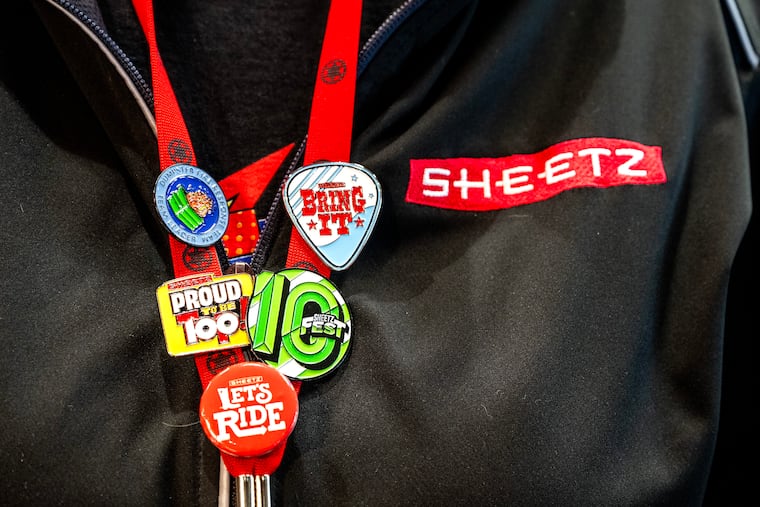 An employee wears Sheetz pins on her lanyard during the grand opening Thursday, Feb. 12, 2026 of the first Sheetz store in the Philly suburbs - solid Wawa territory.