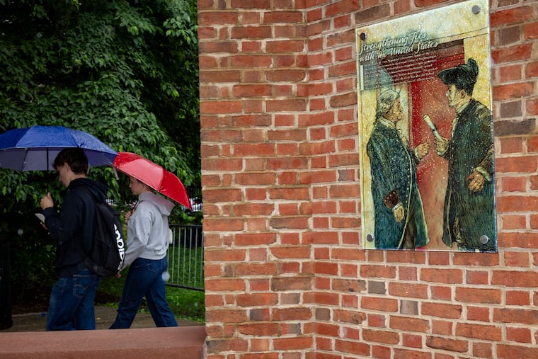 A couple walks past the President’s House on Tuesday.