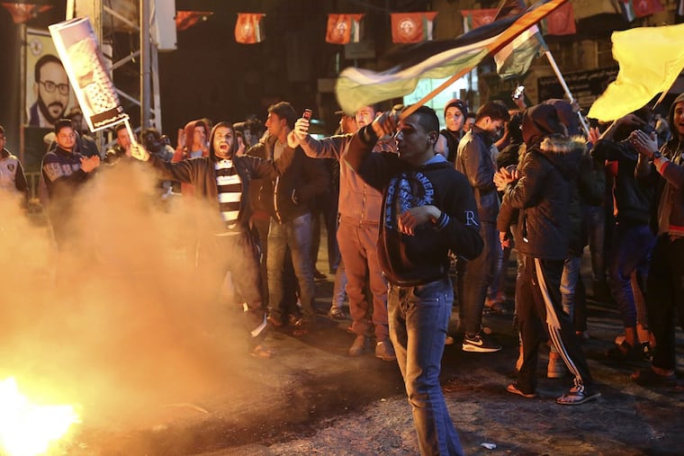 Palestinian protestors burn tires as they wave national flags in Gaza City on Wednesday after President Trump recognized Jerusalem as Israel’s capital.