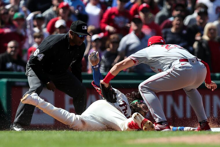 Phillies center fielder Brandon Marsh gets tagged out at third after getting caught in a rundown.