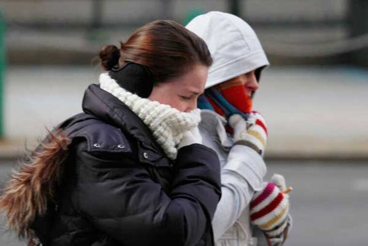 People bundled up at Market and Juniper Streets last winter. Today is expected to be Philadelphia's coldest day since March. (MICHAEL S. WIRTZ / Staff Photographer)