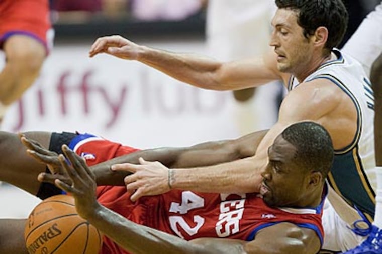 Elton Brand goes to the floor for a loose ball as Wizards guard Kirk Hinrich reaches. (Evan Vucci/AP)