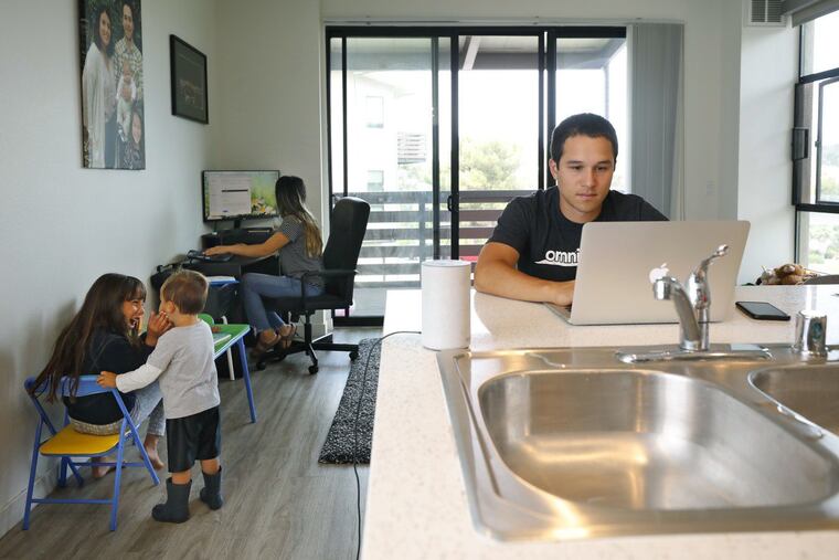 Lucas Fernandez of La Mesa, Calif., is working a hybrid model where he works at home part of the time and at the office other times. His wife, Deicy, is also working from home, and the two do so while watching their children, Vienna, 7 and Lucas Jr., 2.
