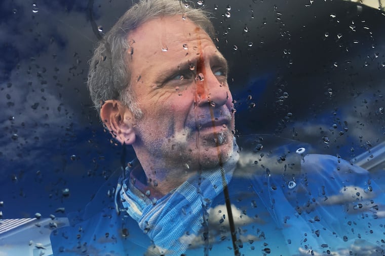 In this photo taken on Monday, Oct. 10, 2016, Greek photojournalist Yannis Behrakis looks on during a visit at Normandy, France. Yannis Behrakis, a Pulitzer Prize-winning photojournalist, has died. He was 58. His death Saturday, March 2, 2019 was confirmed by his employers, Reuters, where he had worked since 1987. Behrakis had long been ill with cancer. (AP Photo/Enric Marti)