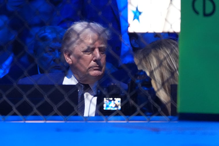 President Donald Trump talks with first lady Melania Trump at UFC Freedom 250 on the South Lawn of the White House, Sunday.