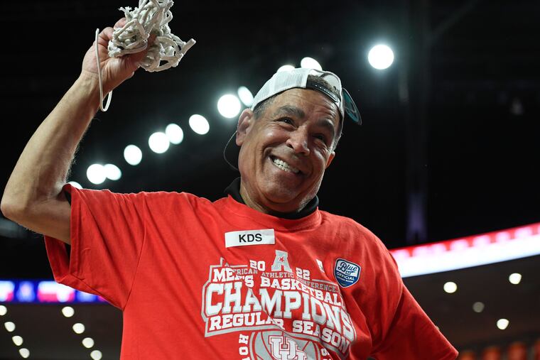 Houston head coach Kelvin Sampson cutting the net after Houston became American Athletic Conference regular-season champion after a game against Temple on March 3.