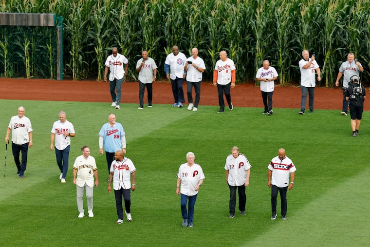 Hall of Famers, including former Phillies Mike Schmidt and Steve Carlton, walk out of a cornfield before the start of the Field of Dreams game on Thursday in Dyersville, Iowa.