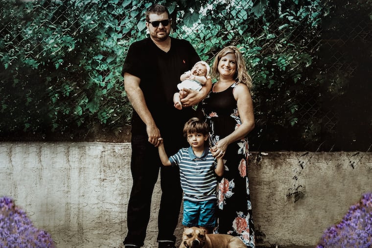 Brad and Lauren with son Braeden, daughter Emma and "big brother" Winston, their 75-pound rescue dog.