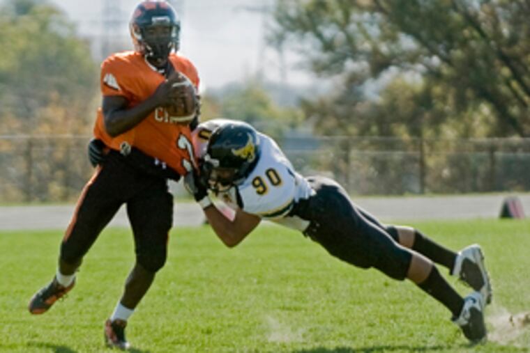 Bulls defensive end Lansing Hodges pulls down Clippers quarterback Al Payne in the first quarter. Payne left the game with an ankle injury in the second.