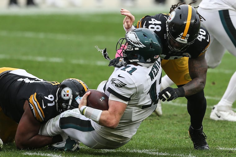 Eagles' quarterback Carson Wentz is sacked by Steelers' Stephon Tuitt (91) and Bud Dupree (48) during the 4th quarter at Heinz Field in Pittsburgh, Sunday, October 11, 2020 Steelers beat he Eagles 38-29.