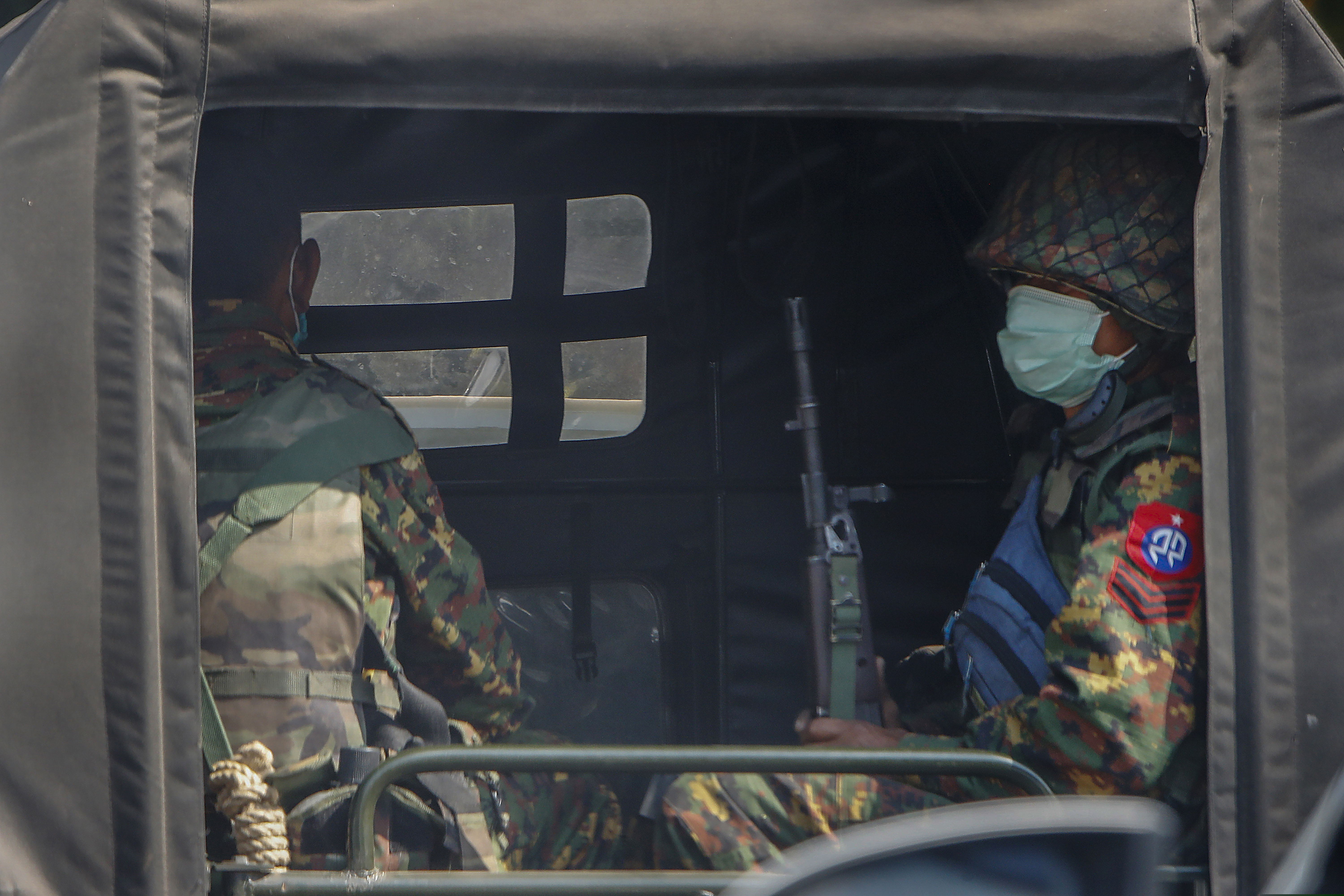 Armed soldiers travel in a convoy of army vehicles patrolling in Mandalay, Myanmar, on Wednesday.