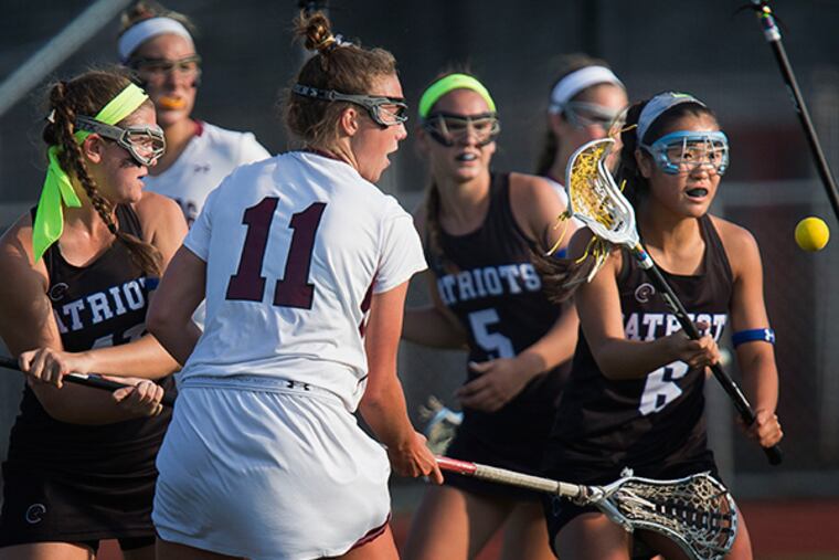 Conestoga's Sondra Dickey (11) chases the ball with Great Valley's Brooke Lionetti (41), left, Courtney Cortese (5) and Lucy Haubold (6) in the first period of District 1 girls high school lacrosse semifinals at Haverford High School in Havertown, Pa on Tuesday night, May 19, 2015. (LAURENCE KESTERSON / For The Inquirer)