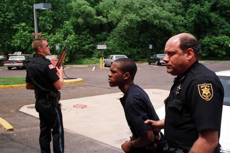 Ivory King, seen here in 1998 being escorted into a Bristol Township courtroom, pleaded guilty to killing four people at a house party. Decades later, King's sentence is up for review, thanks to a 2016 Supreme Court decision banning juvenile life sentences.