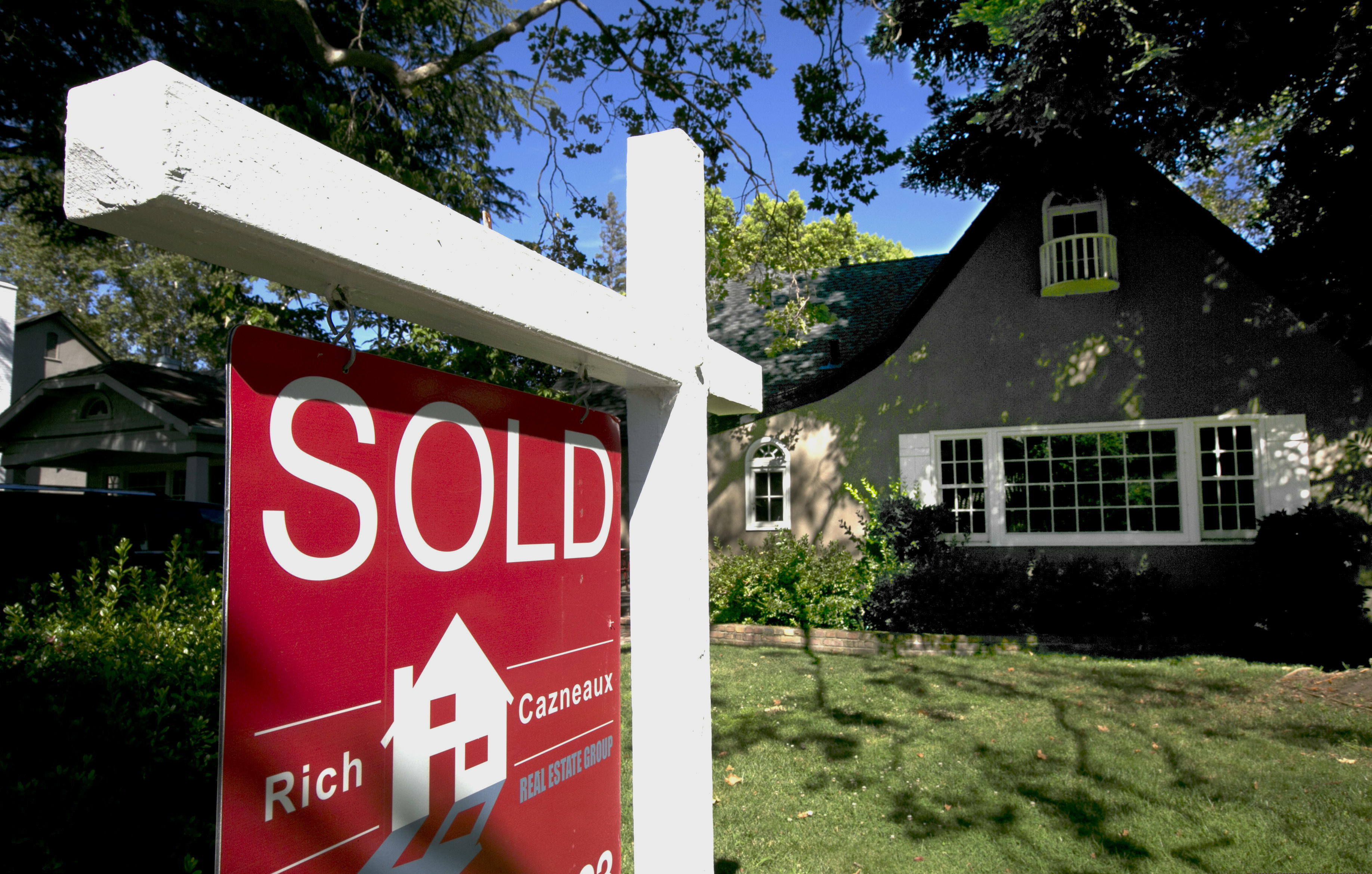 FILE photo shows a "Sold" sign displayed in front of a house.