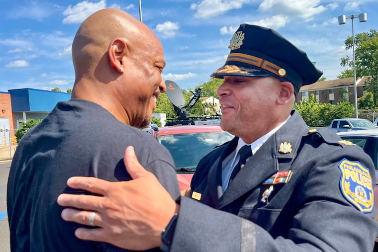 Joel Fitzgerald embraces Philadelphia Police Inspector Nicholas Smith at a dedication ceremony for Joel's son Christopher Fitzgerald at the Bustleton Post Office Sunday. The post office was renamed after Christopher Fitzgerald, a Temple police officer killed in 2023.