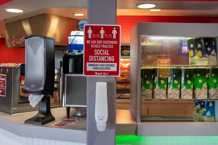Social distancing signs are shown at the Water Tower Cinema in Lansdale on Friday.