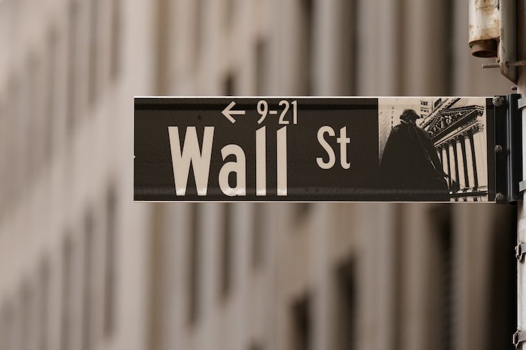 A Wall Street sign is seen outside of the New York Stock Exchange on March 30.