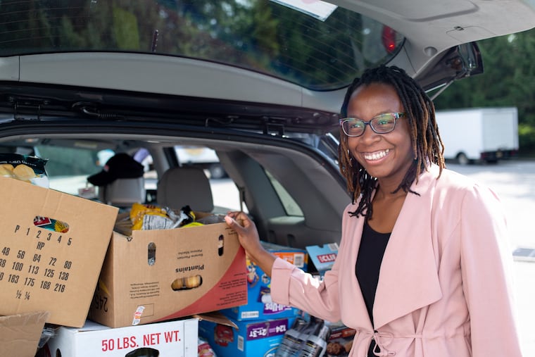Shontae Smarr, director of Philly Food Rescue, outside Fresh Grocer in Wyncote with a car full of groceries that will be donated to people in Kensington.