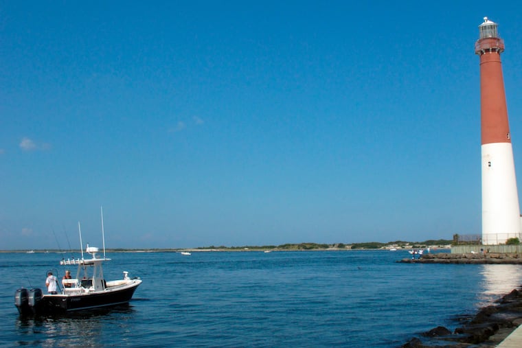 This Sept. 18, 2021 photo shows a boat near the Barnegat Inlet and Barnegat Lighthouse in Barnegat Light, N.J.