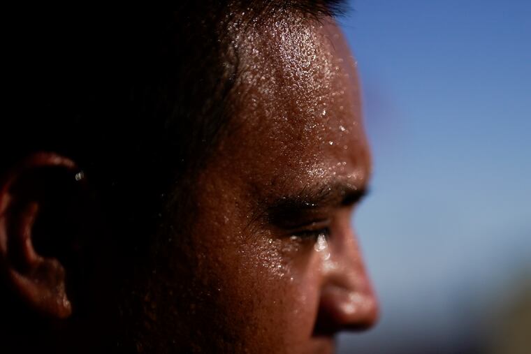 Sweat covers the face of Juan Carlos Biseno as afternoon temperatures reach 115 degrees Fahrenheit on July 19, 2023, in Calexico, Calif.
