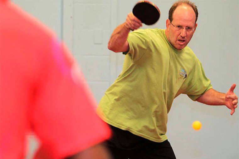 Developer/restaurateur/table tennis impresario Ken Weinstein in action at the Trolley Car Table Tennis Club in East Falls. (Akira Suwa / Staff Photographer)
