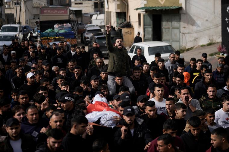 Mourners carry the body of Mahmoud Abu Haniyeh, 17, during his funeral at the town of Azzun, West Bank, Sunday. The Palestinian Health Ministry says Abu Haniyeh was killed during clashes with the Israeli army on Saturday in the town of Azzun.