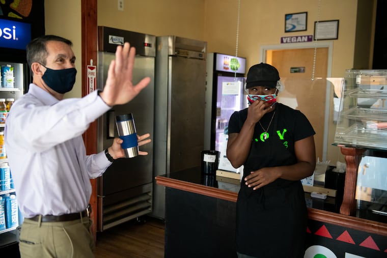Pennsylvania Auditor General and Democratic congressional candidate Eugene DePasquale (left) with LaQuana Barber, owner of House of Vegans restaurant in Harrisburg, on Saturday.