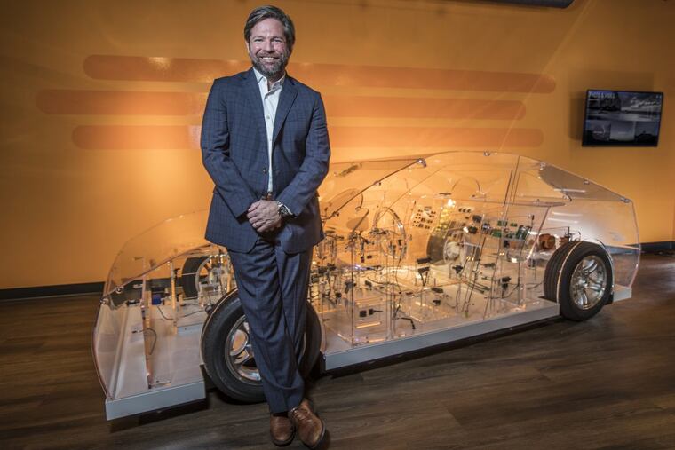 Terrence Curtin, TE Connectivity CEO, seen with a transparent car, showing all the connectors they manufacture, that go into your automobile.