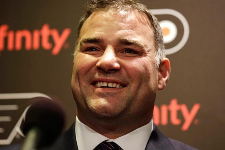 Former Philadelphia Flyers' Eric Lindros laughs while answering a question during a news conference before an NHL hockey game against
the Minnesota Wild, Thursday, Nov. 20, 2014, in Philadelphia. Lindros
and teammate John Leclair are being inducted into the Flyers Hall of
Fame in a ceremony before the game. (Matt Slocum/AP)