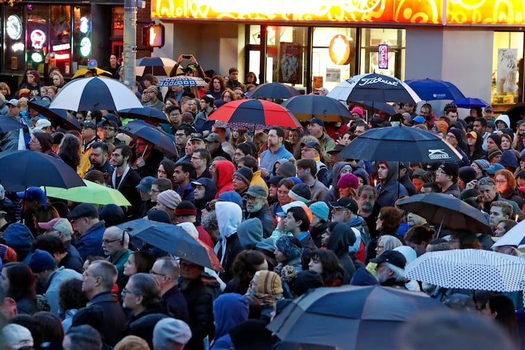 A crowd gathers at the intersection of Murray Ave. and Forbes Ave. in the Squirrel Hill section of Pittsburgh during a memorial vigil for the victims of the synagogue shooting.