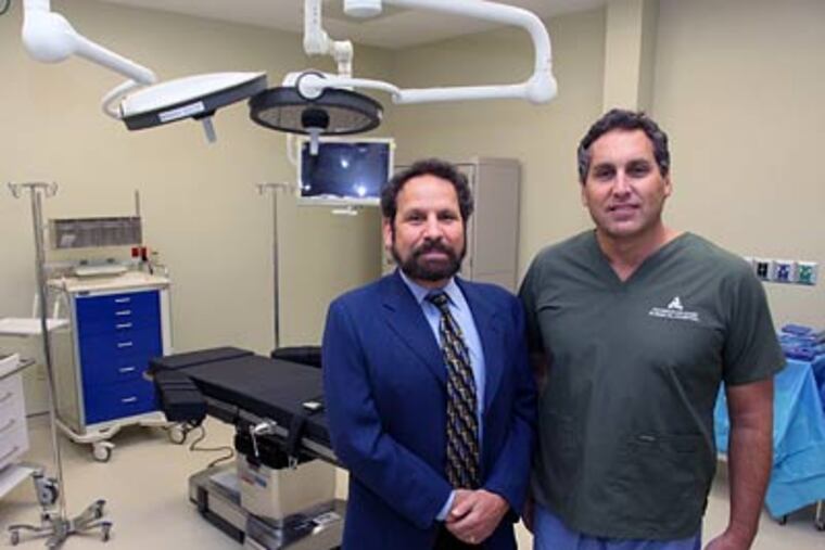 Founding doctors Larry Feiner (left) and Frederic Liss in an operating room at the new Physicians Care Surgical Hospital in Royersford, Montgomery County. (Laurence Kesterson / Staff Photographer)