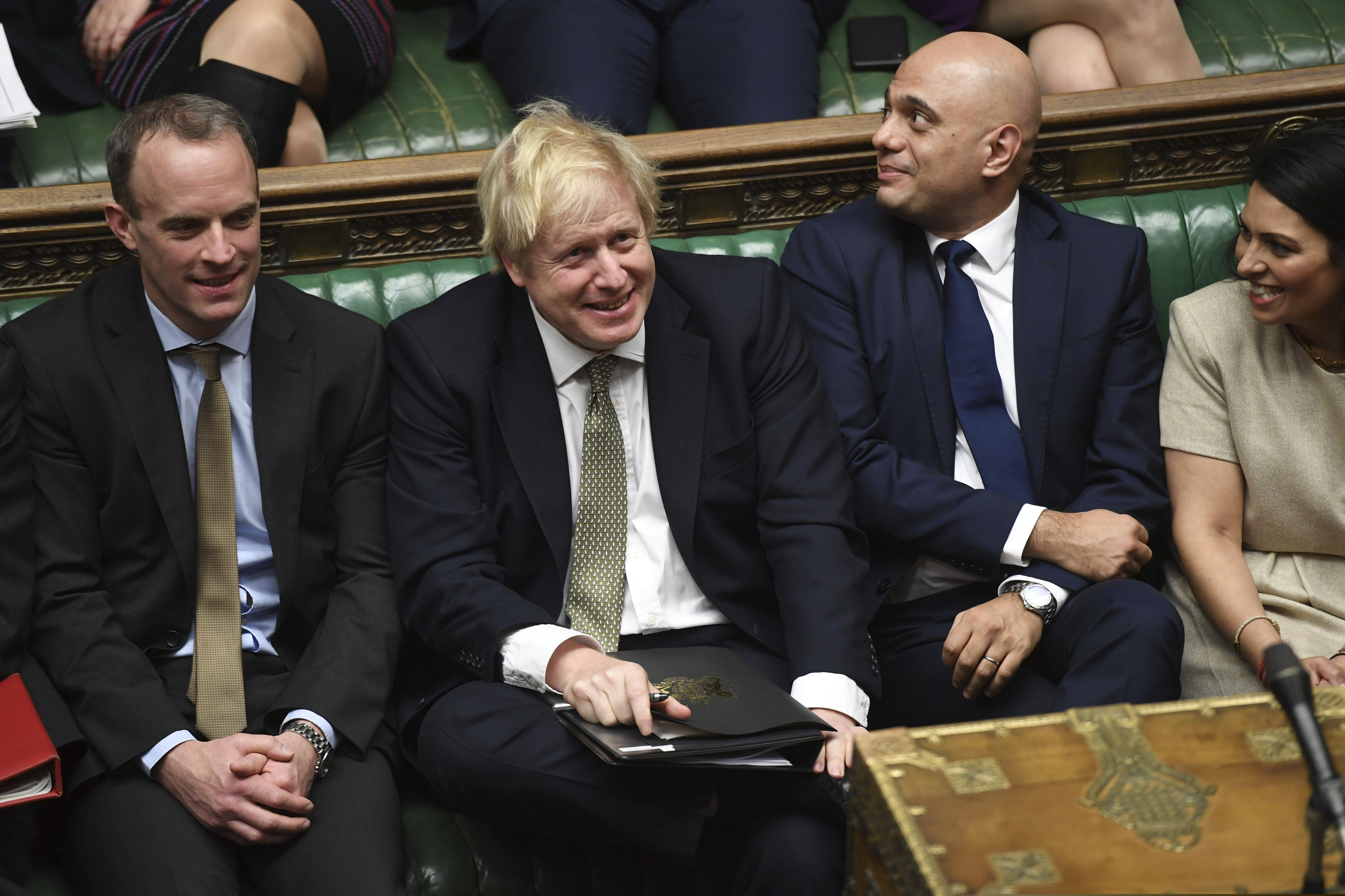 In this photo made available by the UK Parliament, Britain's Prime Minister Boris Johnson, center, attends the debate in the House of Commons, London, Thursday Dec. 19, 2019.