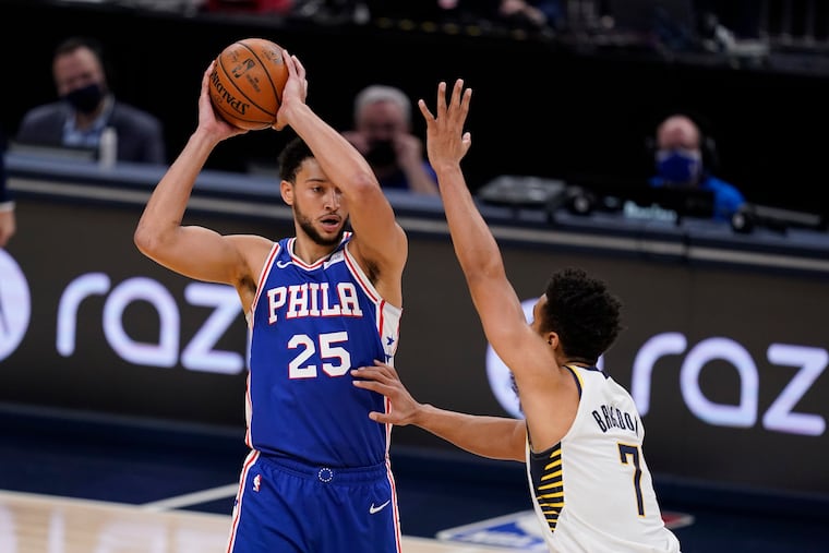 The 76ers' Ben Simmons (25) is defended by Indiana Pacers' Malcolm Brogdon (7) during Friday's preseason game.